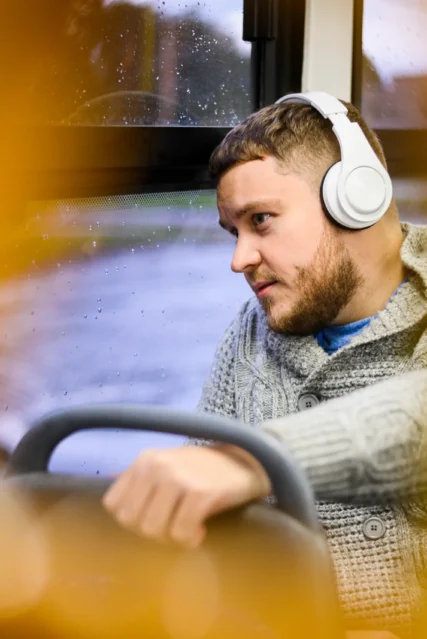 man-with-headphones-traveling-by-bus